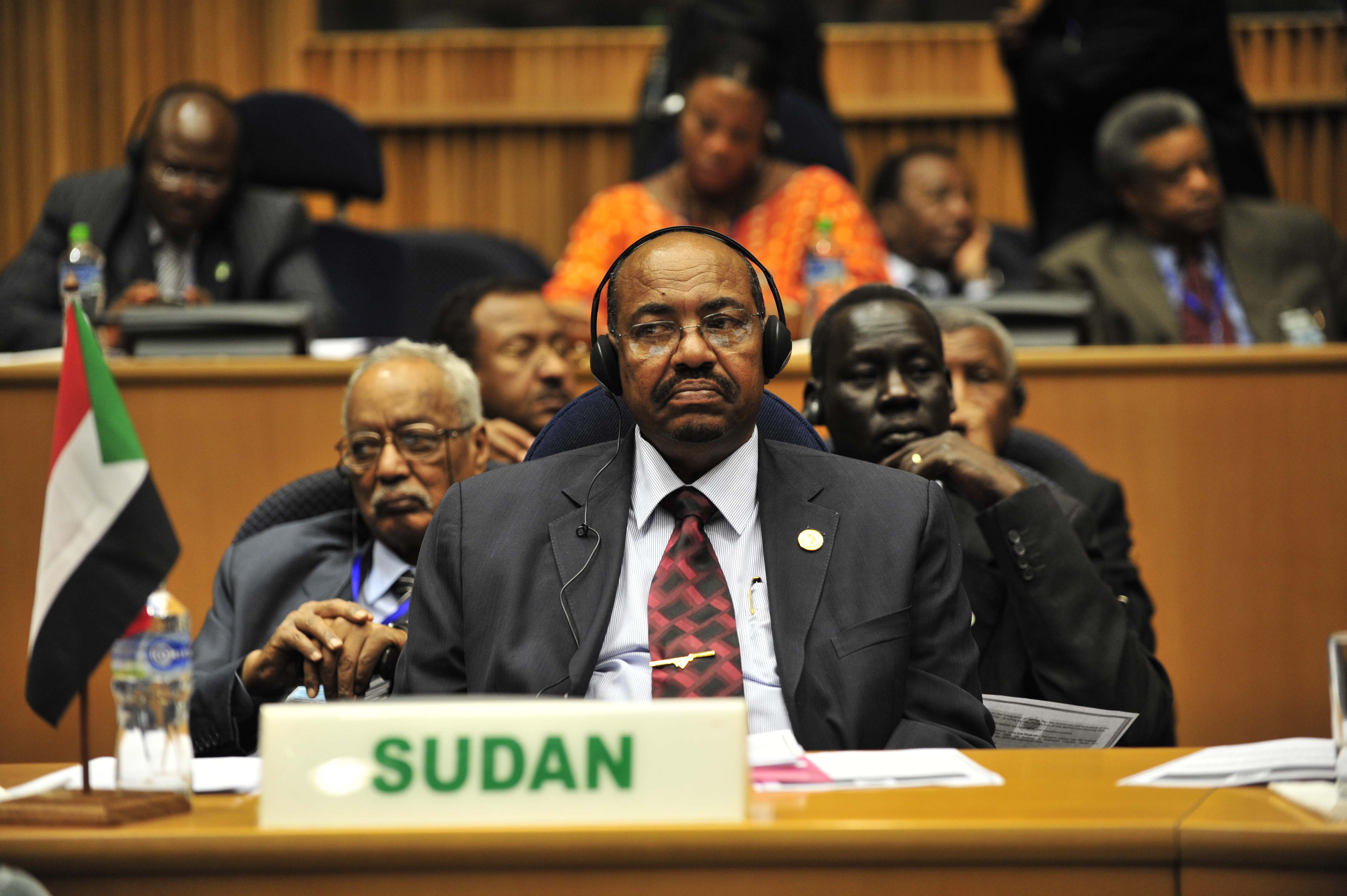 Omar Hassan Ahmad al-Bashir, president of Sudan, listens to translated remarks during the opening of the 20th session of The New Partership for Africa’s Development (NEPAD)